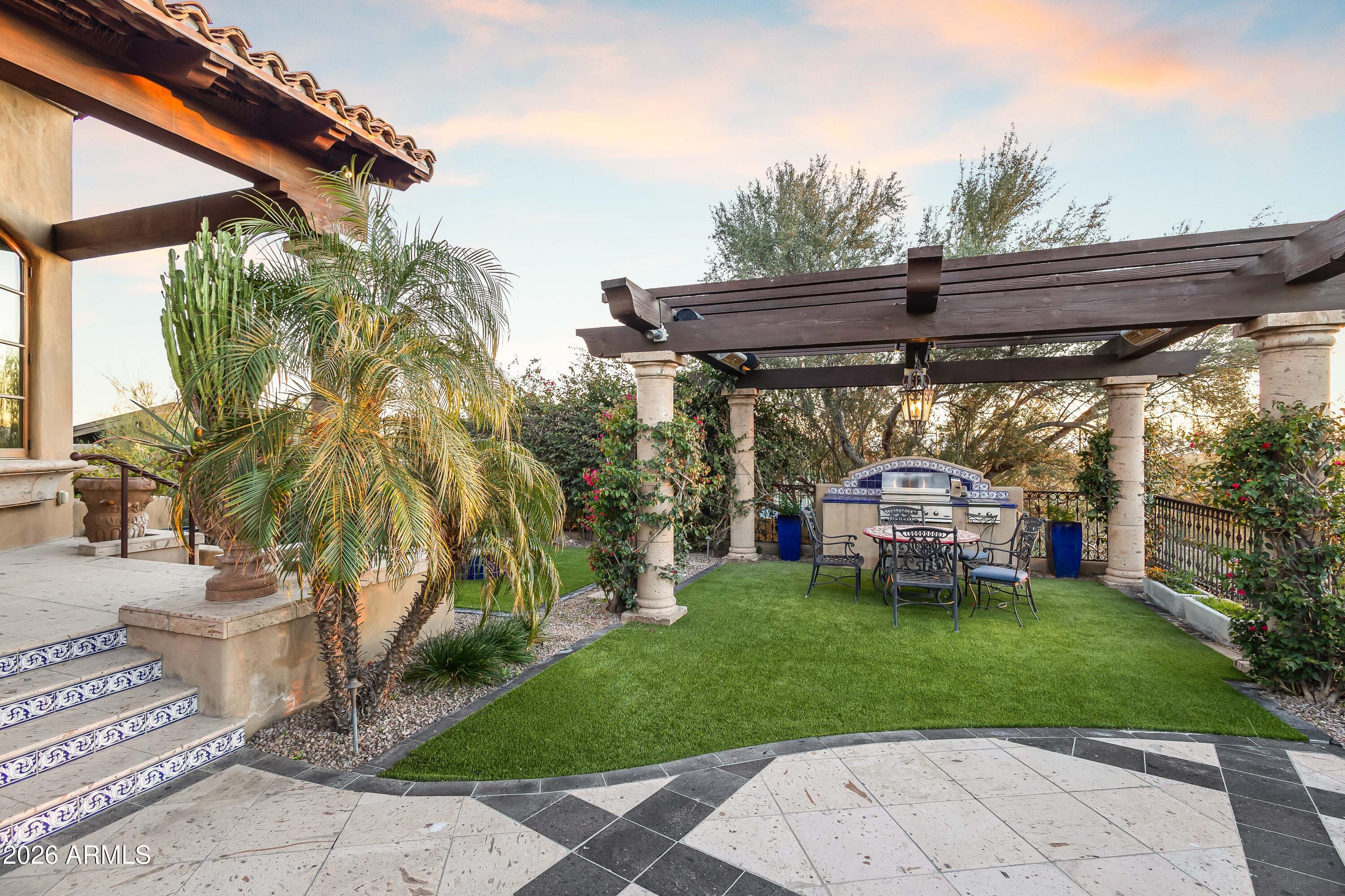 3900 East Bethany Home Road Paradise Valley, AZ 85253 - Photo 28 of 51 a view of a backyard with table and chairs under an umbrella