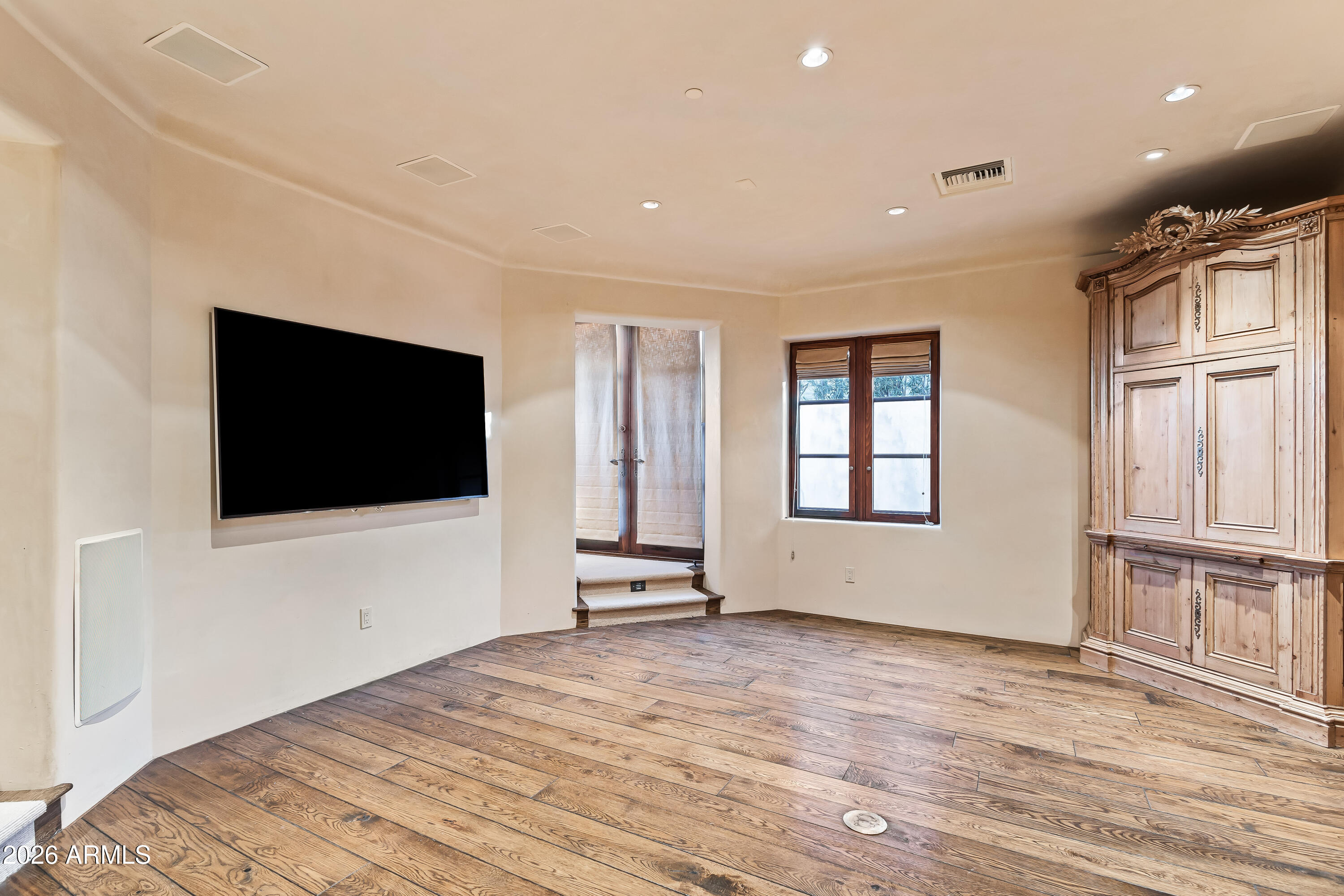 3900 East Bethany Home Road Paradise Valley, AZ 85253 - Photo 41 of 51 a view of a livingroom with wooden floor and a flat screen tv