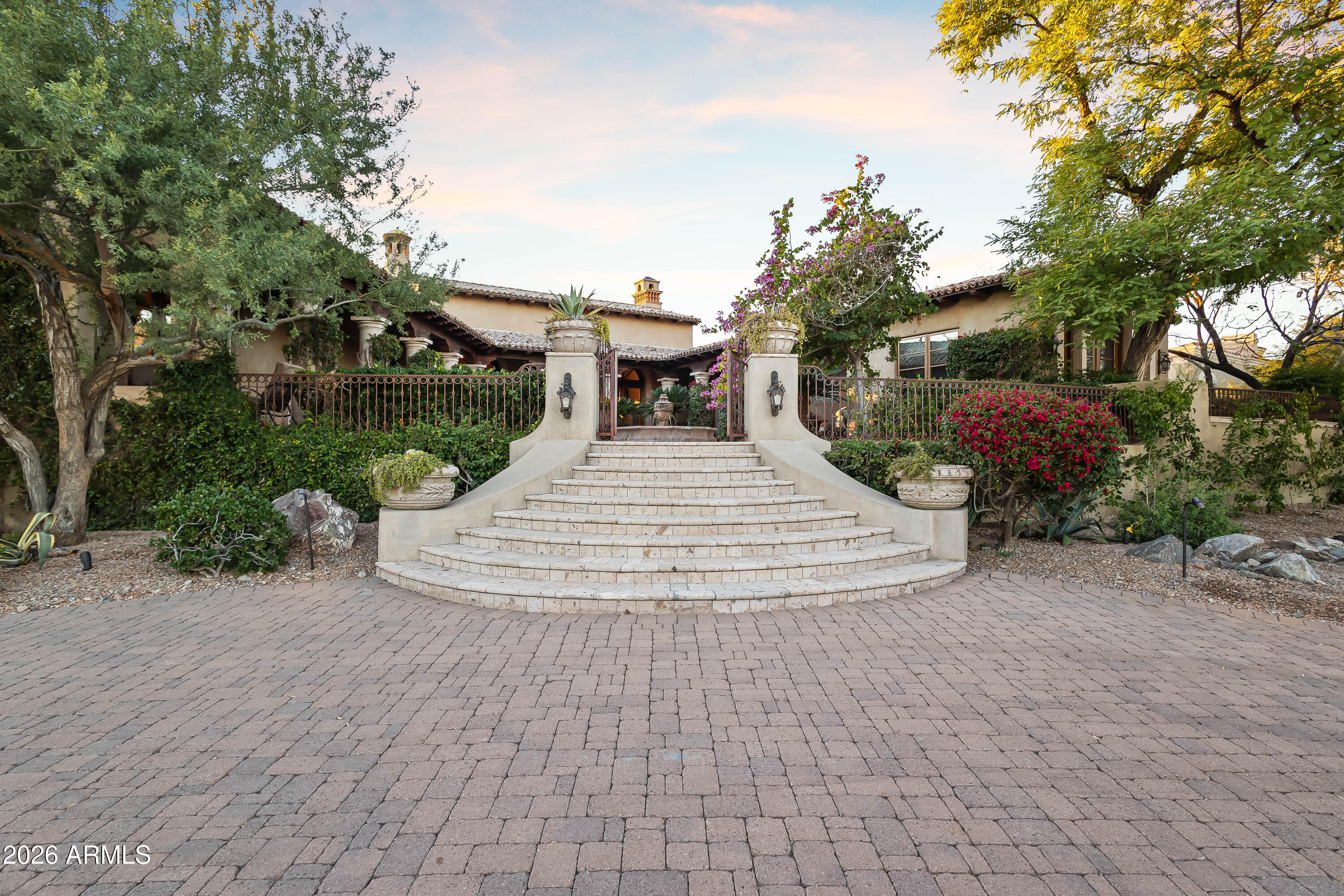 3900 East Bethany Home Road Paradise Valley, AZ 85253 - Photo 44 of 51 a view of a white house with a yard and potted plants