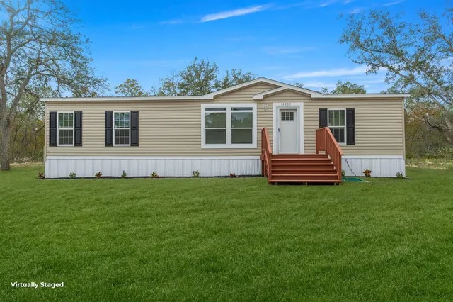 a view of a house with a backyard