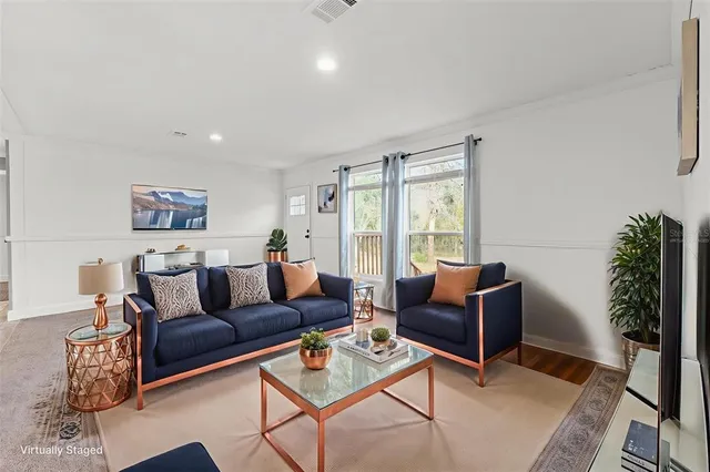 a living room with furniture potted plant and a window