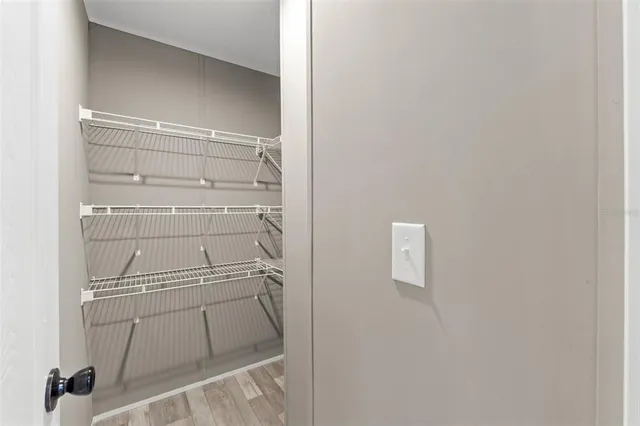 a view of walk in closet with empty racks