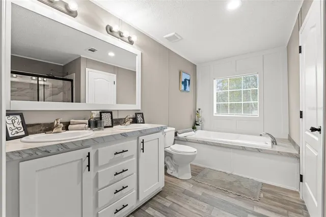a spacious bathroom with a double vanity sink and a mirror
