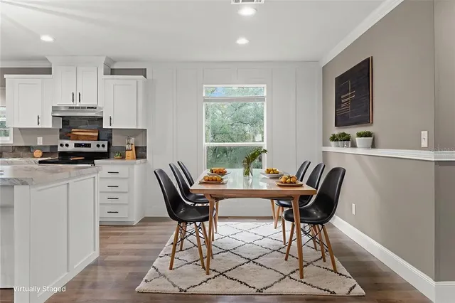 a view of a dining room with furniture window and wooden floor