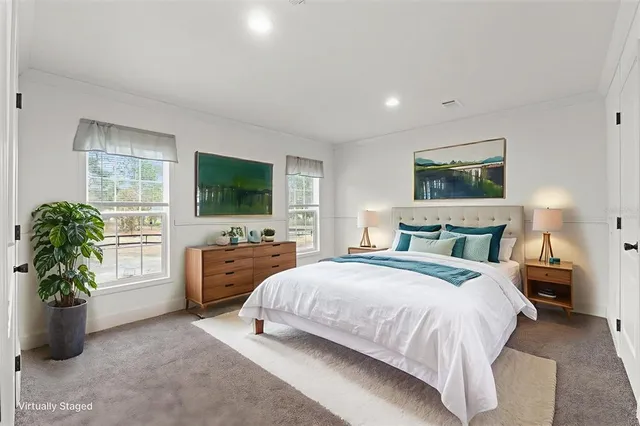 a spacious bedroom with a bed and a flat screen television