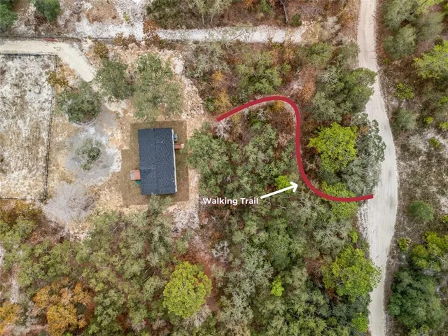 a backyard of a house with lots of green space and lake view