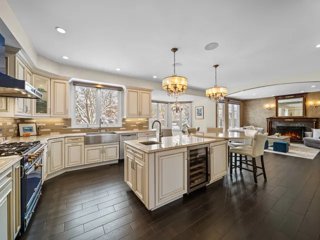 a large white kitchen with lots of counter space a sink and appliances