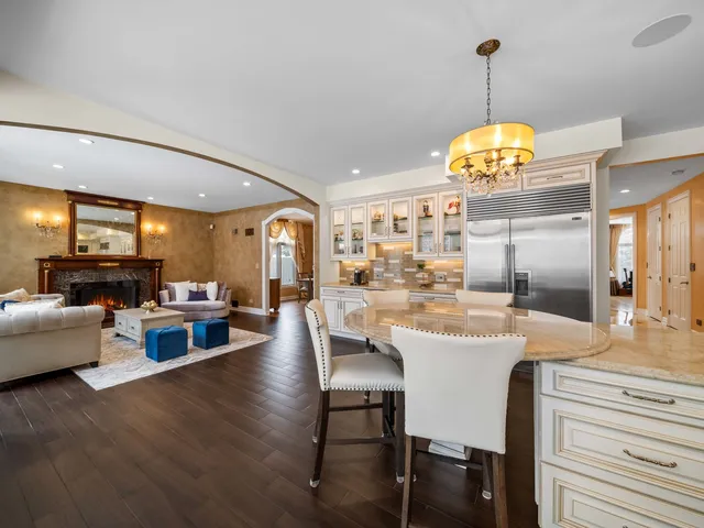 a kitchen with counter space dining table and stainless steel appliances