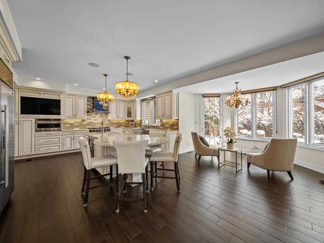 a large kitchen with a table and chairs