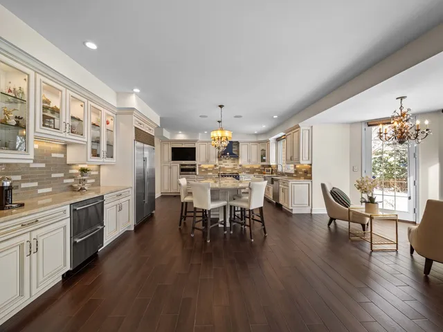 a kitchen with stainless steel appliances granite countertop a sink and a large window