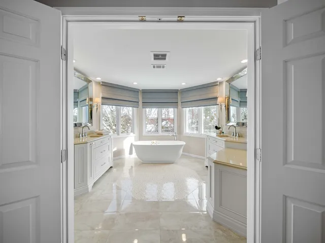 a bedroom with a large bed and a large window