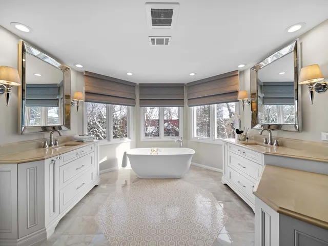 a bathroom with a granite countertop sink a mirror and a toilet
