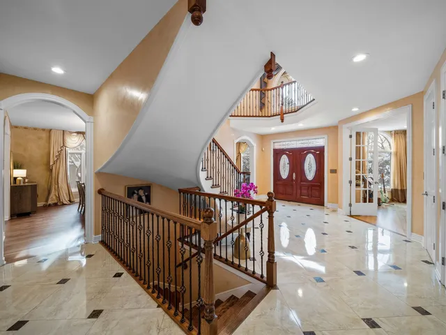 a view of entryway bedroom and hall with wooden floor