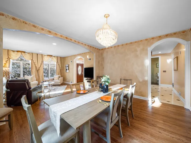 a view of a dining room with furniture wooden floor and chandelier