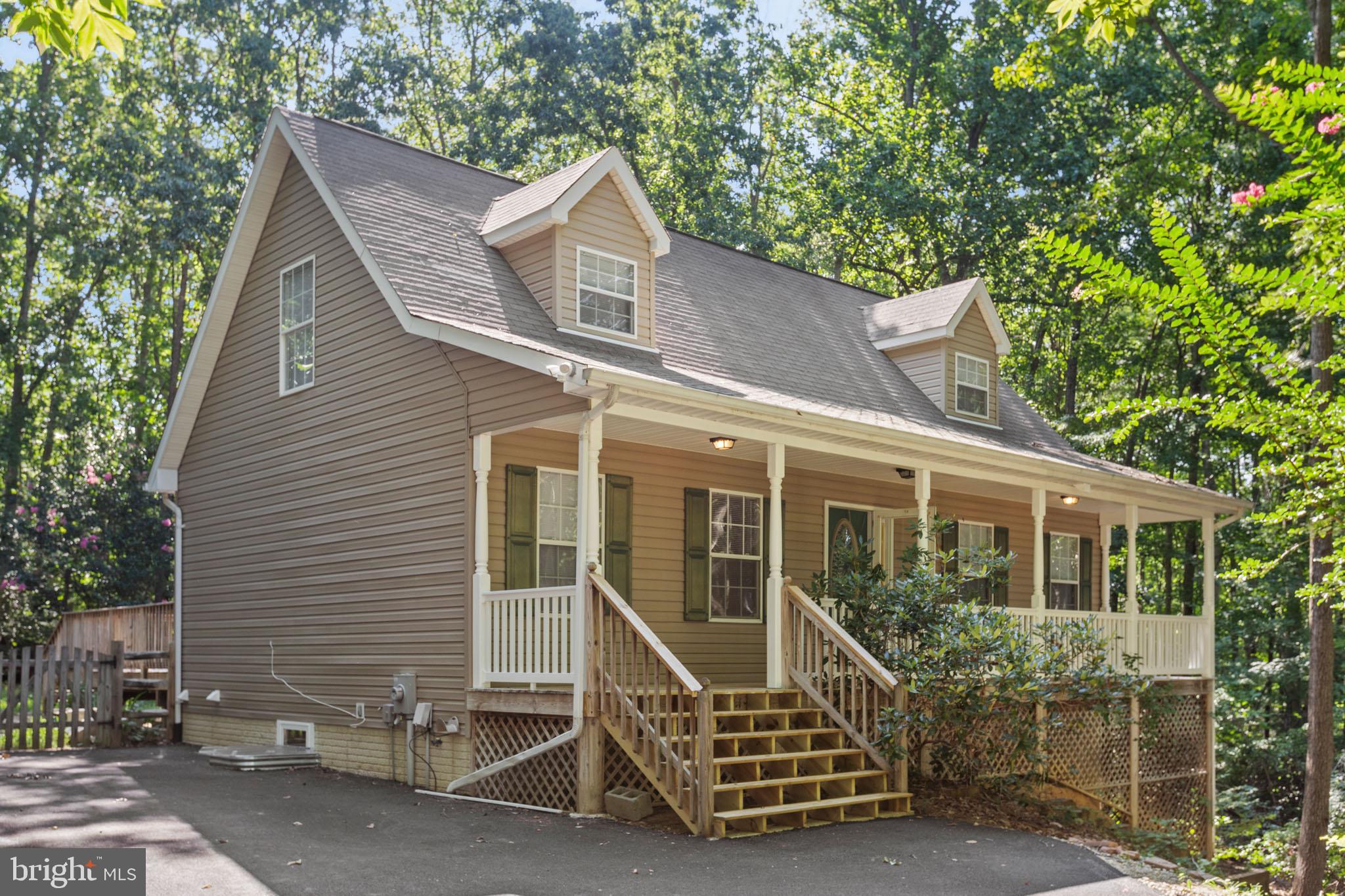 7830 Pine Boulevard Lusby, MD 20657 - Photo 1 of 30 a front view of a house with balcony