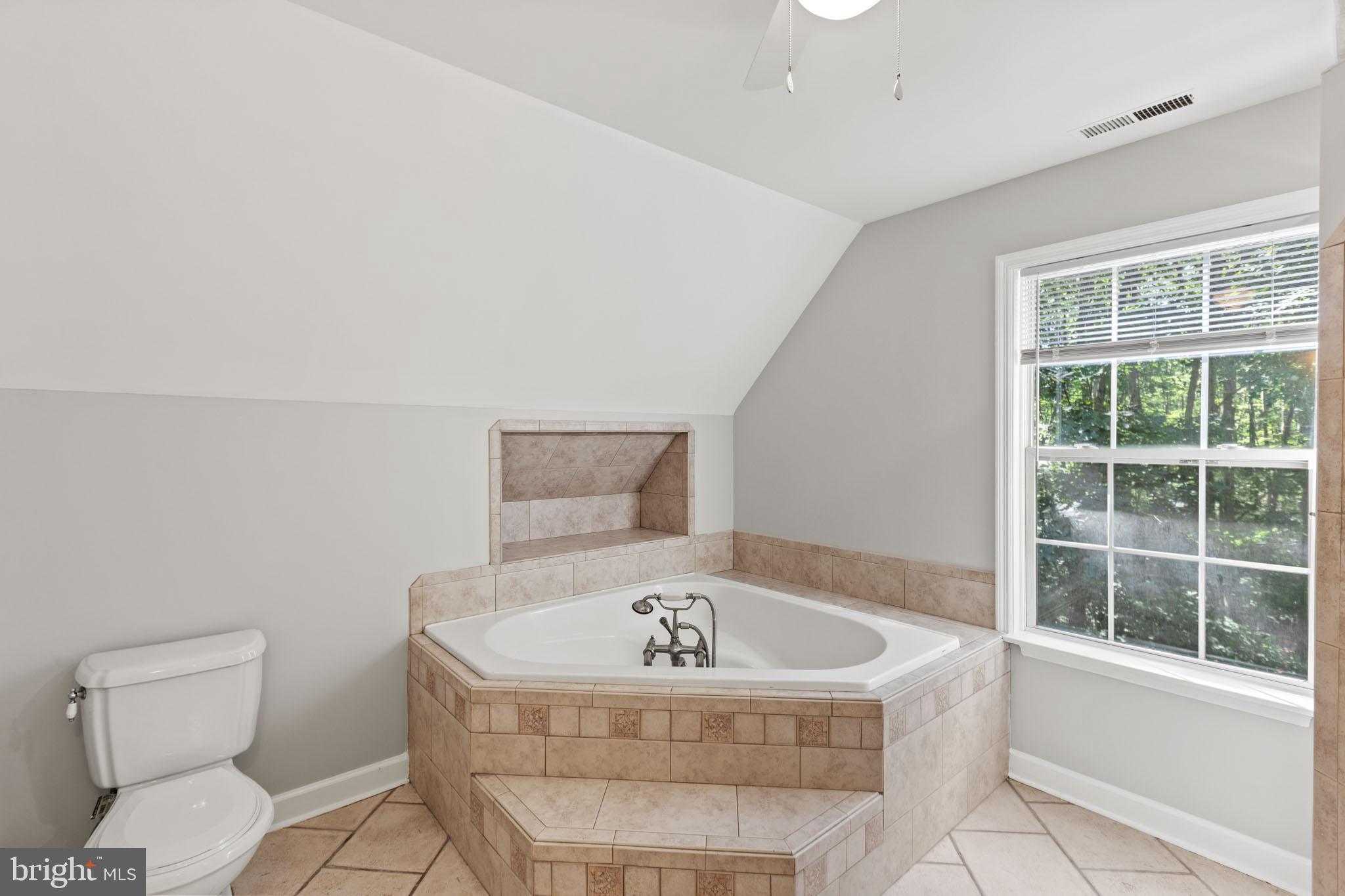 7830 Pine Boulevard Lusby, MD 20657 - Photo 20 of 30 a bathroom with a bathtub and a shower