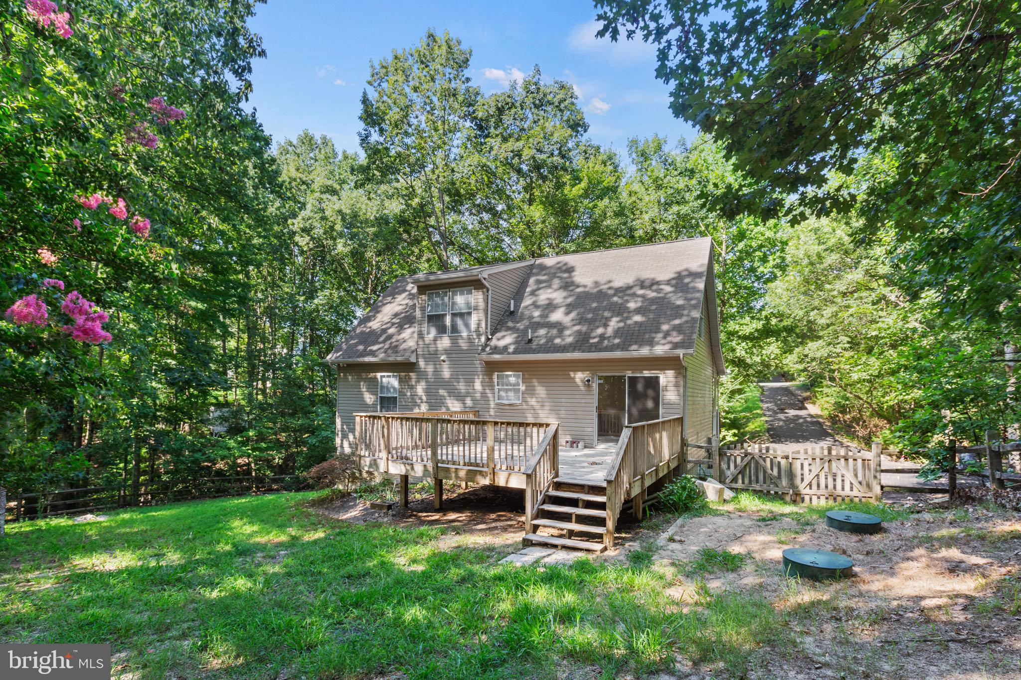 7830 Pine Boulevard Lusby, MD 20657 - Photo 28 of 30 an outdoor view of house with backyard and seating space