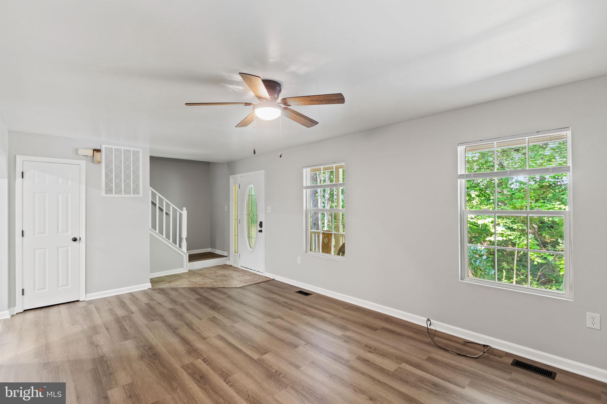 7830 Pine Boulevard Lusby, MD 20657 - Photo 5 of 30 a view of empty room with wooden floor and fan