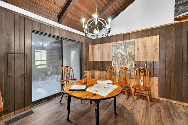 a view of a room with furniture and wooden floor