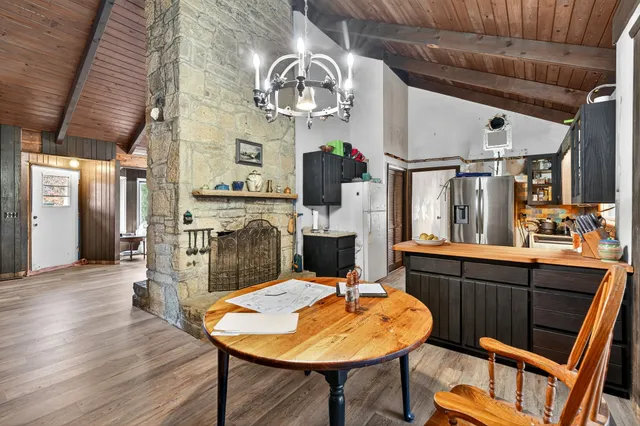 a kitchen with stainless steel appliances wooden floors and wooden cabinets
