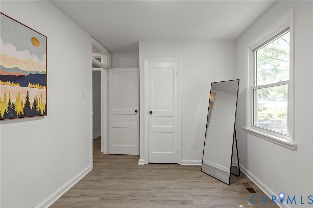 3406 Meadowbridge Road Richmond, VA 23222 - Photo 27 of 41 a view of an empty room with wooden floor and a window
