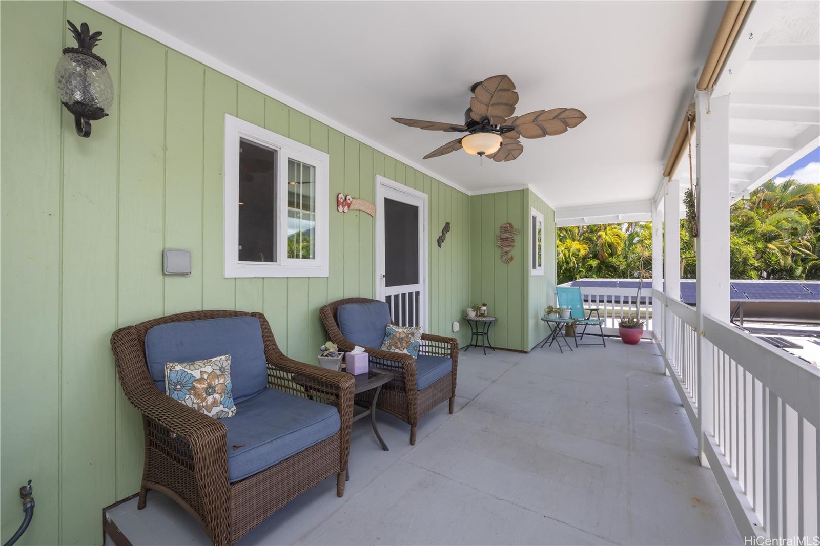 409 Wanaao Road Kailua, HI 96734 - Photo 17 of 25 a living room with furniture a chandelier and a window