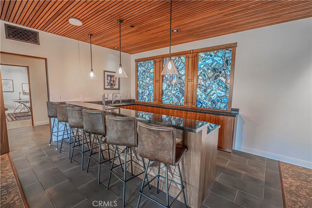 3030 Templeton Road Templeton, CA 93465 - Photo 35 of 75 This one-of-a-kind bar showcases a breathtaking backlit geode stone at its entrance, creating a masterpiece you won’t see anywhere else. And not to mention the custom slat ceiling.