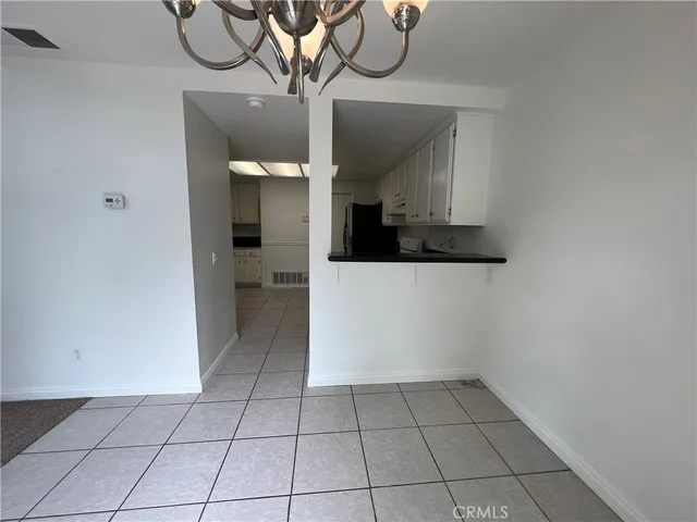 a view of an entryway wooden floor and chandelier