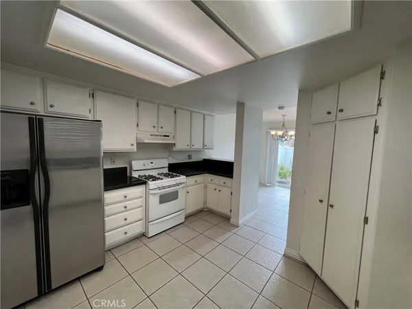 a kitchen with granite countertop a sink and a stove top oven