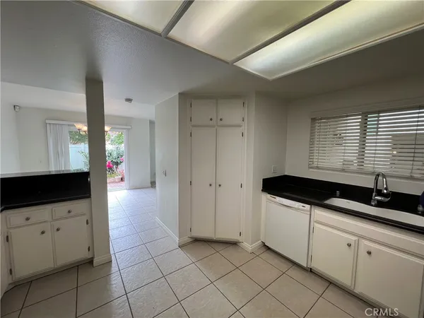a view of a kitchen with an entryway and a hallway
