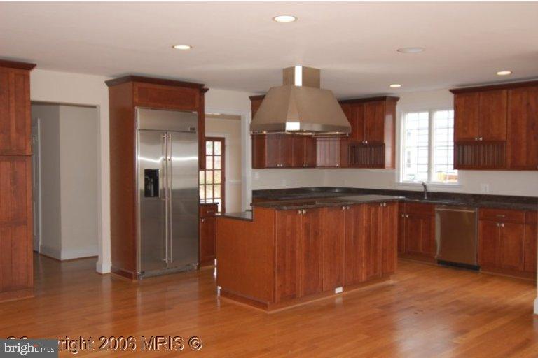 4416 Ridge Street Chevy Chase, MD 20815 - Photo 12 of 20 a kitchen with stainless steel appliances granite countertop a refrigerator and a sink