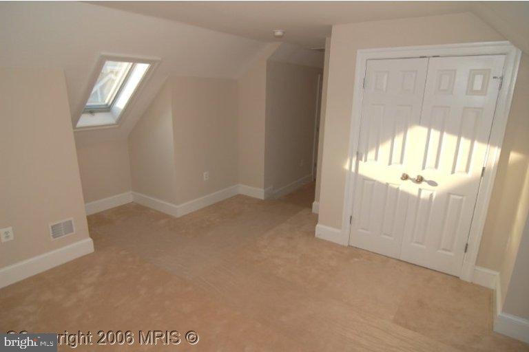 4416 Ridge Street Chevy Chase, MD 20815 - Photo 16 of 20 an empty room with windows