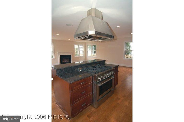4416 Ridge Street Chevy Chase, MD 20815 - Photo 5 of 20 a kitchen with a stove and a hallway