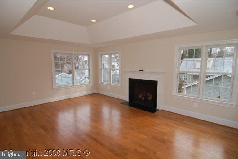 4416 Ridge Street Chevy Chase, MD 20815 - Photo 7 of 20 an empty room with windows and fireplace