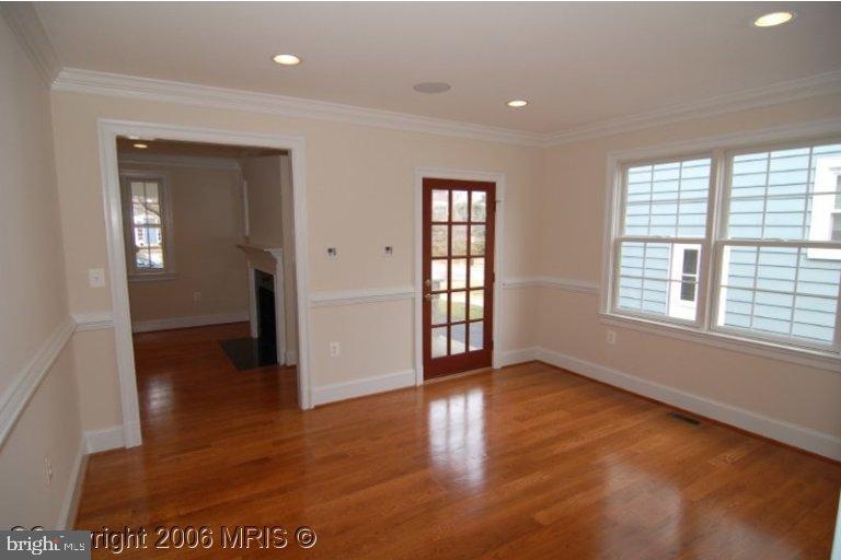 4416 Ridge Street Chevy Chase, MD 20815 - Photo 10 of 20 wooden floor in an empty room with a window