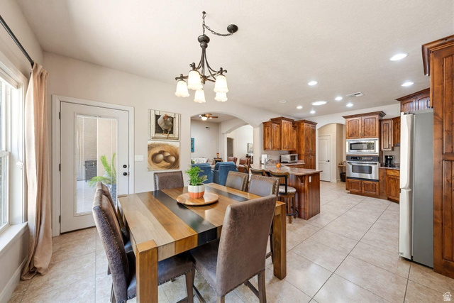 1609 East 10 S Street St. George, UT 84790 - Photo 24 of 68 Open-concept dining area featuring a multi-toned wood table and a wrought iron chandelier