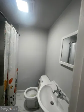 a bathroom with a sink mirror and toilet