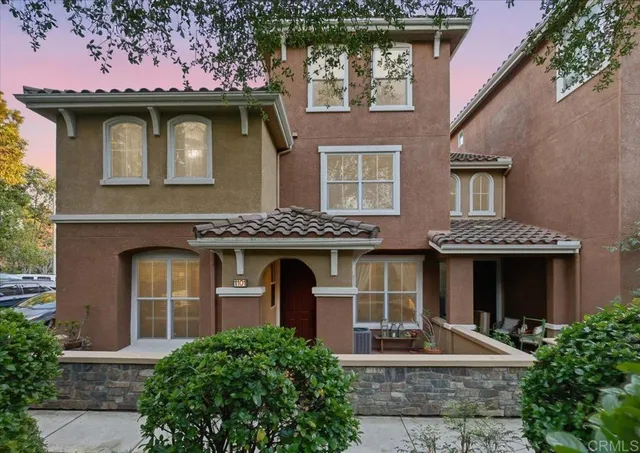 front view of a brick house with a small yard