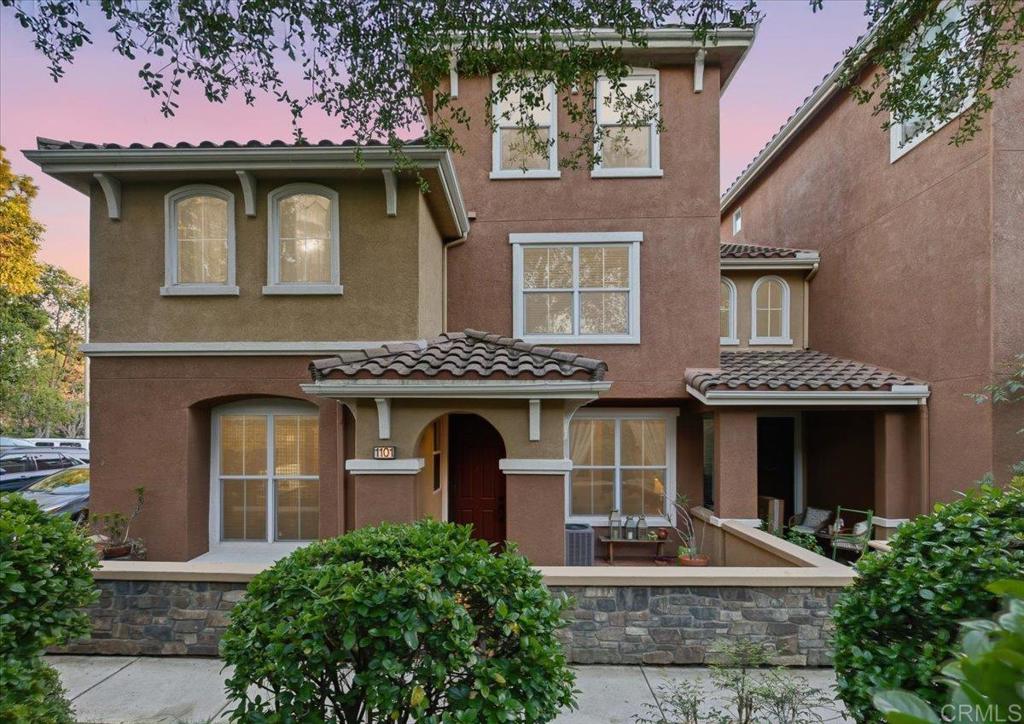 front view of a brick house with a small yard