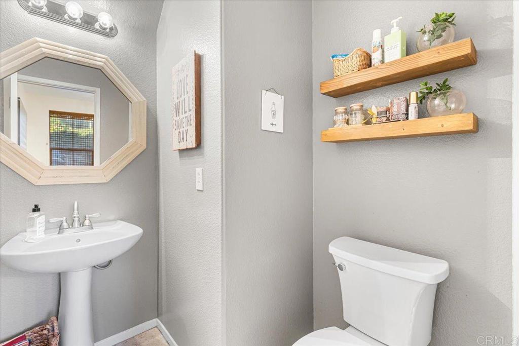 1101 Goddard Street San Marcos, CA 92078 - Photo 21 of 38 a white toilet sitting next to a bathroom sink