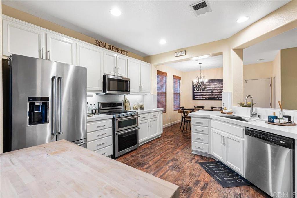 1101 Goddard Street San Marcos, CA 92078 - Photo 23 of 38 a kitchen with stainless steel appliances granite countertop a refrigerator stove microwave and sink
