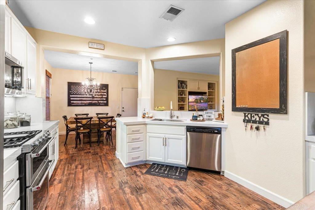1101 Goddard Street San Marcos, CA 92078 - Photo 24 of 38 a kitchen with stainless steel appliances granite countertop a stove and a sink