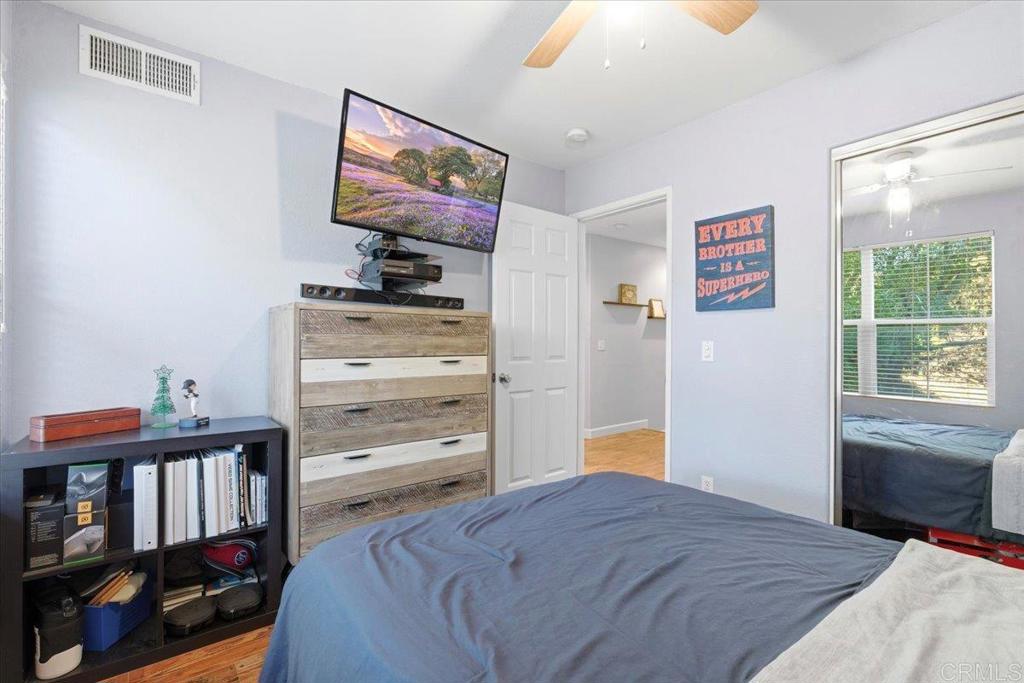 1101 Goddard Street San Marcos, CA 92078 - Photo 26 of 38 a bedroom with a bed and a bookshelf