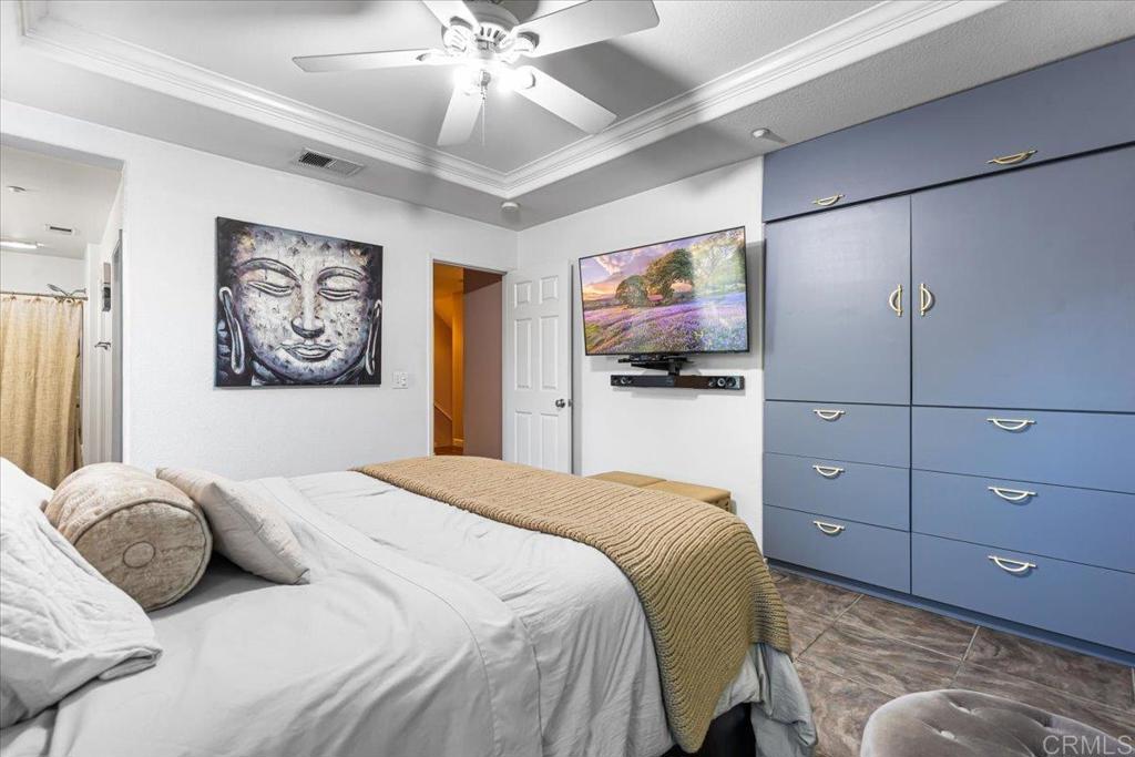 1101 Goddard Street San Marcos, CA 92078 - Photo 32 of 38 a bedroom with a bed and a flat screen tv