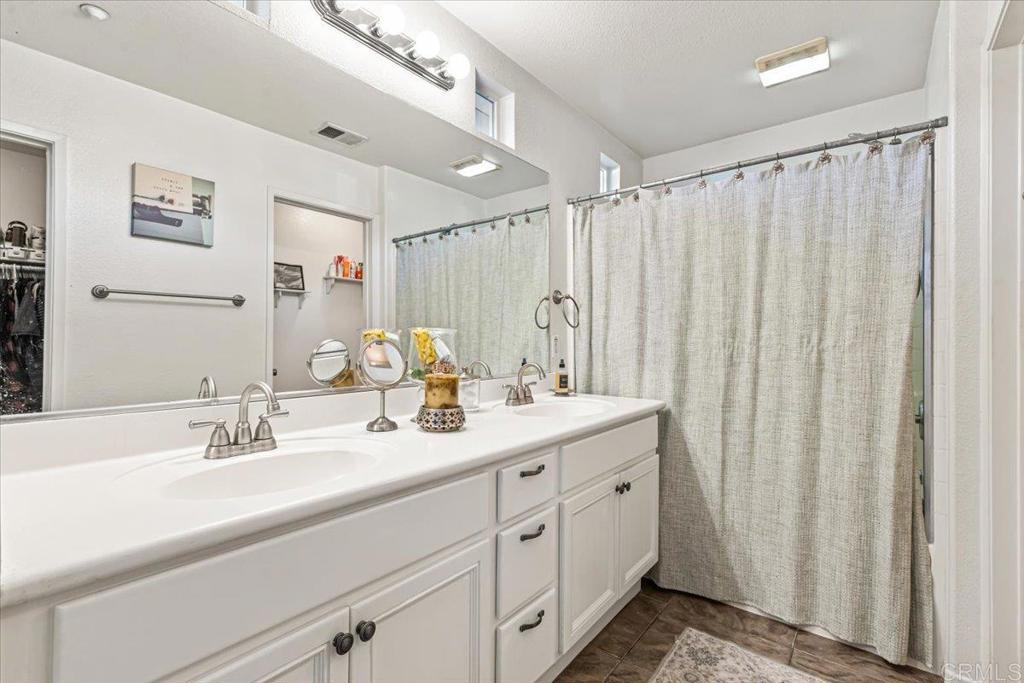 1101 Goddard Street San Marcos, CA 92078 - Photo 33 of 38 a bathroom with a double vanity sink and a mirror
