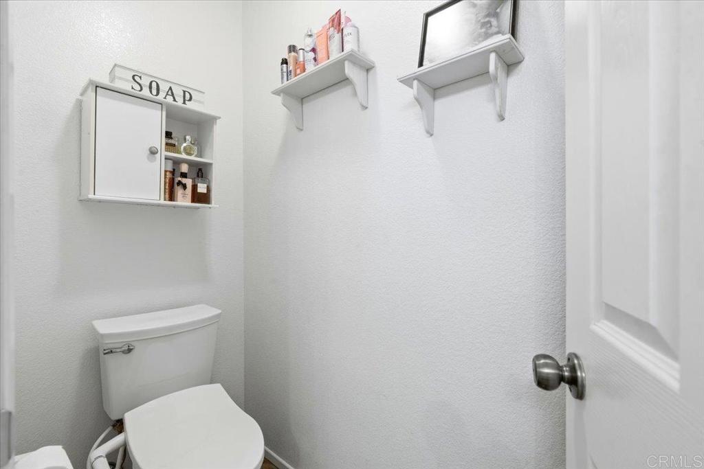 1101 Goddard Street San Marcos, CA 92078 - Photo 35 of 38 a white toilet sitting next to a shower