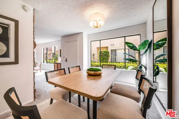 a view of a dining room with furniture window and outside view