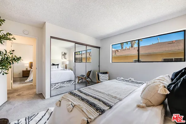 a bedroom with a bed and window
