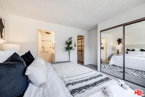 a living room with a bed and a large mirror