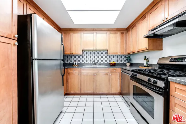a kitchen with a refrigerator a stove a washer and dryer